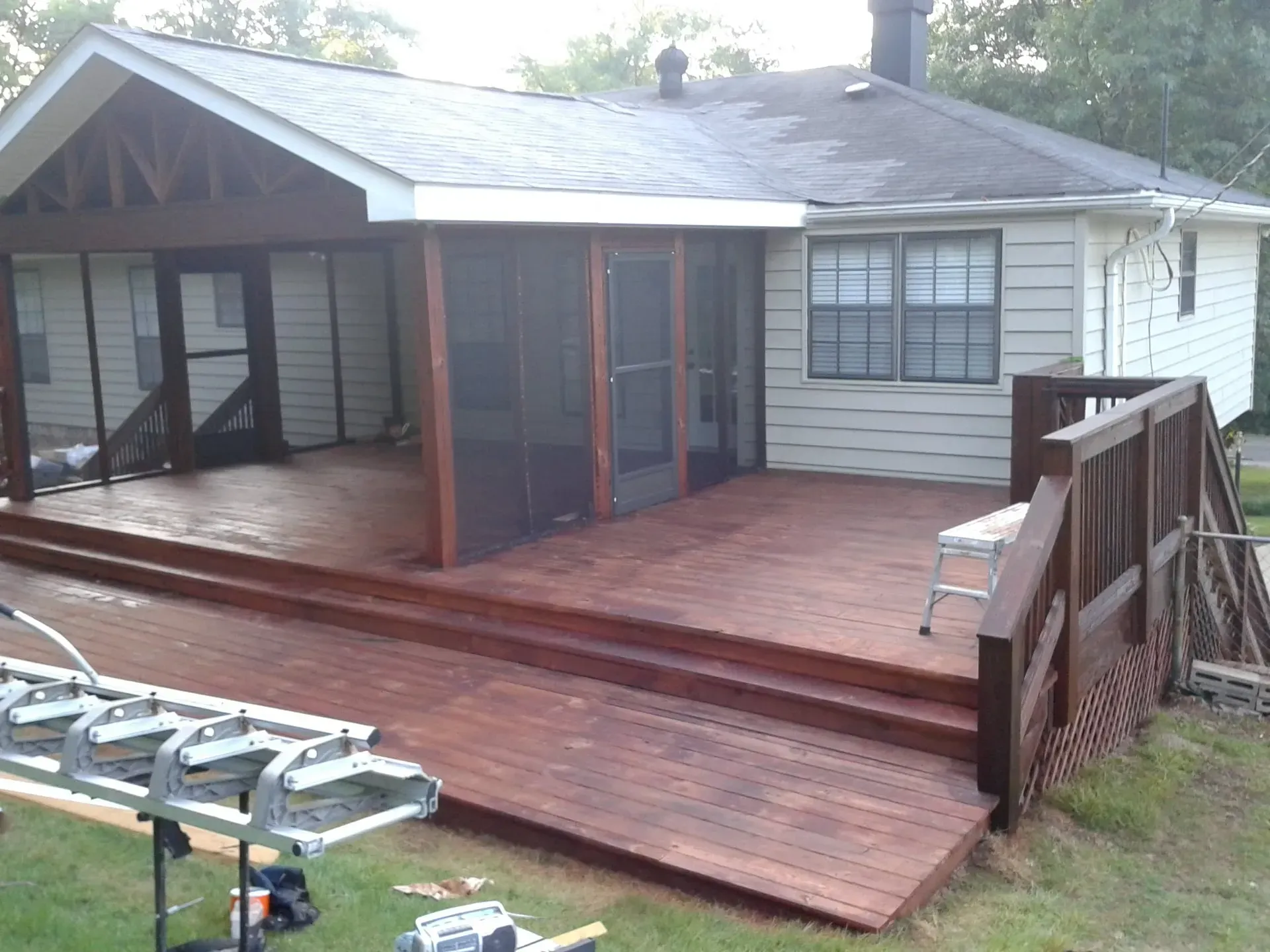 A house with a screened in porch and a wooden deck