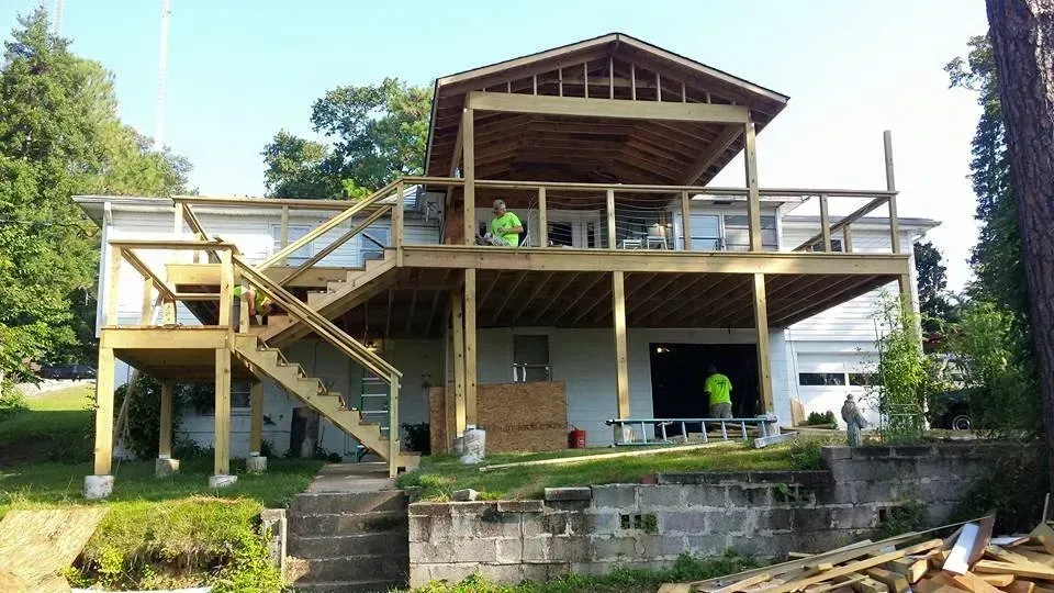 A house with a large wooden deck under construction