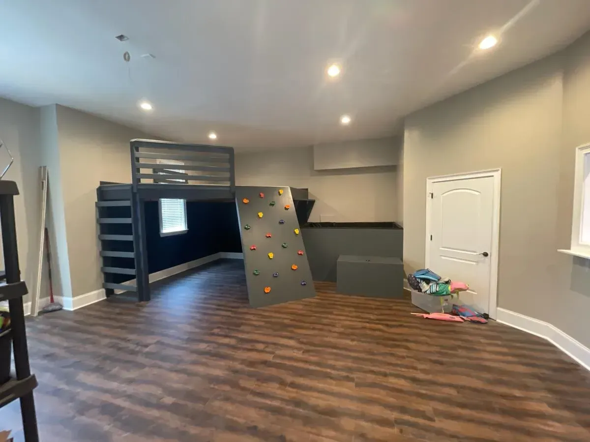 There is a climbing wall in the middle of the room.