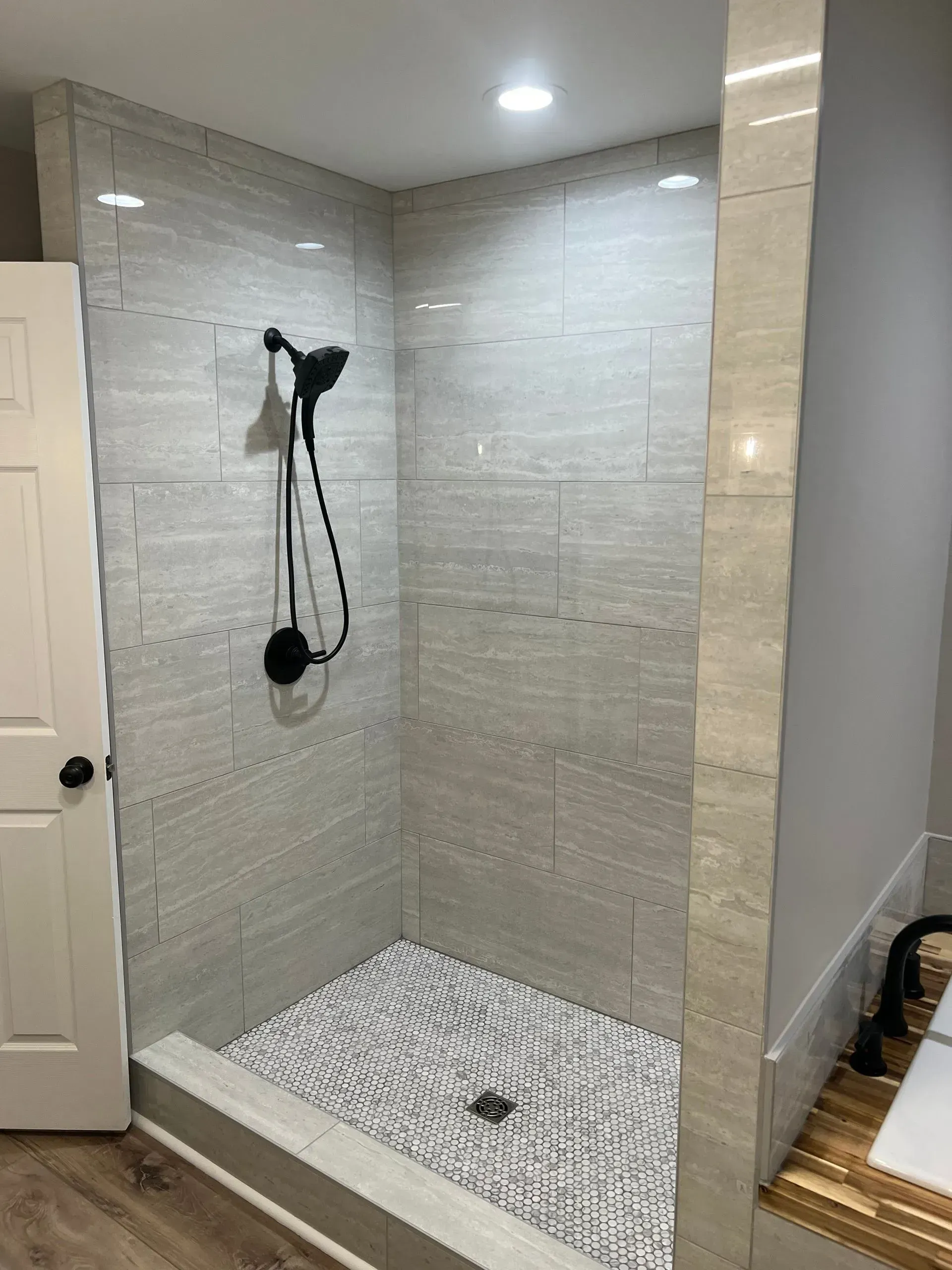 A bathroom with a walk in shower and a bathtub.