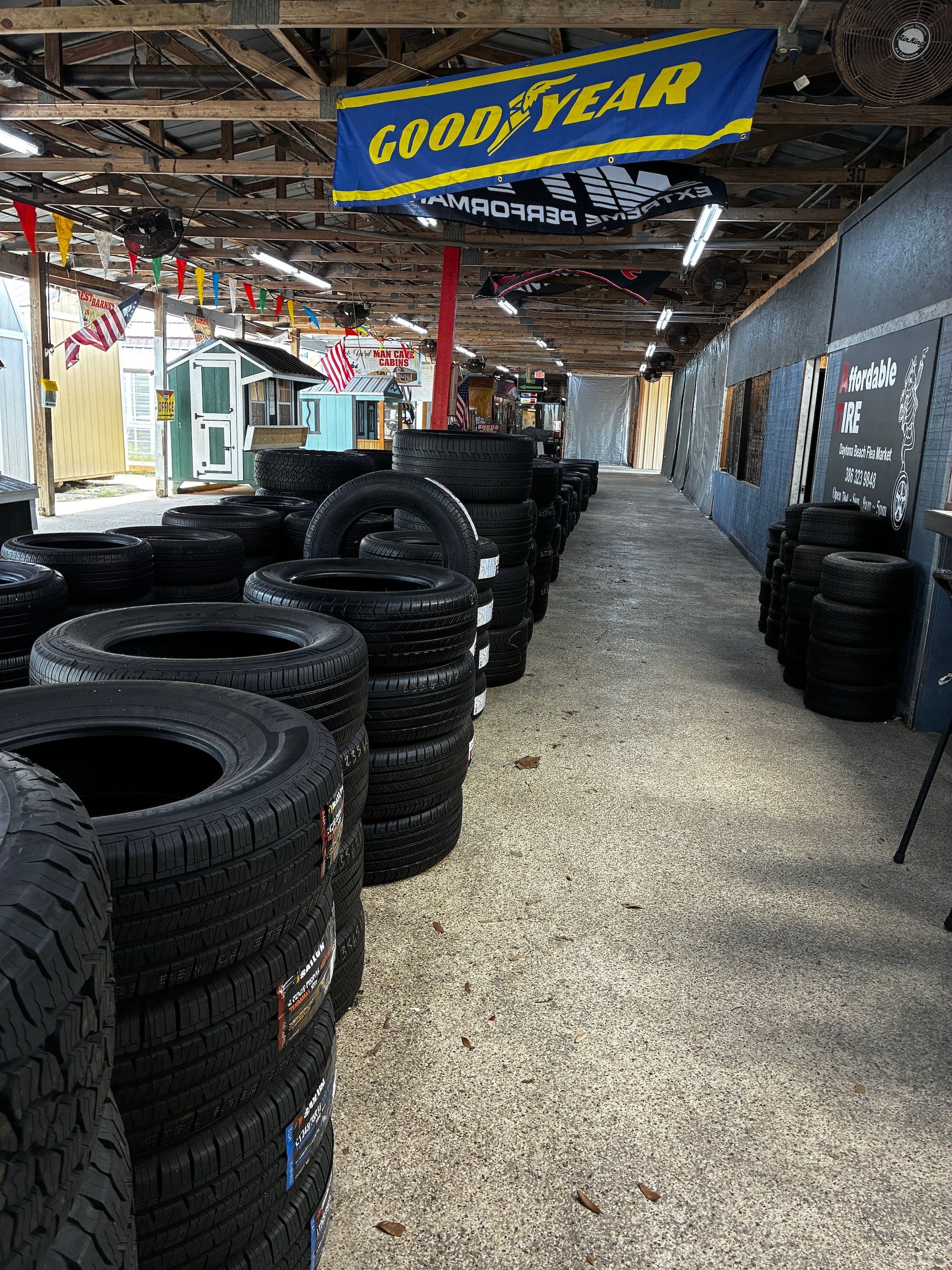 Neatly stacked used tires on a shop floor