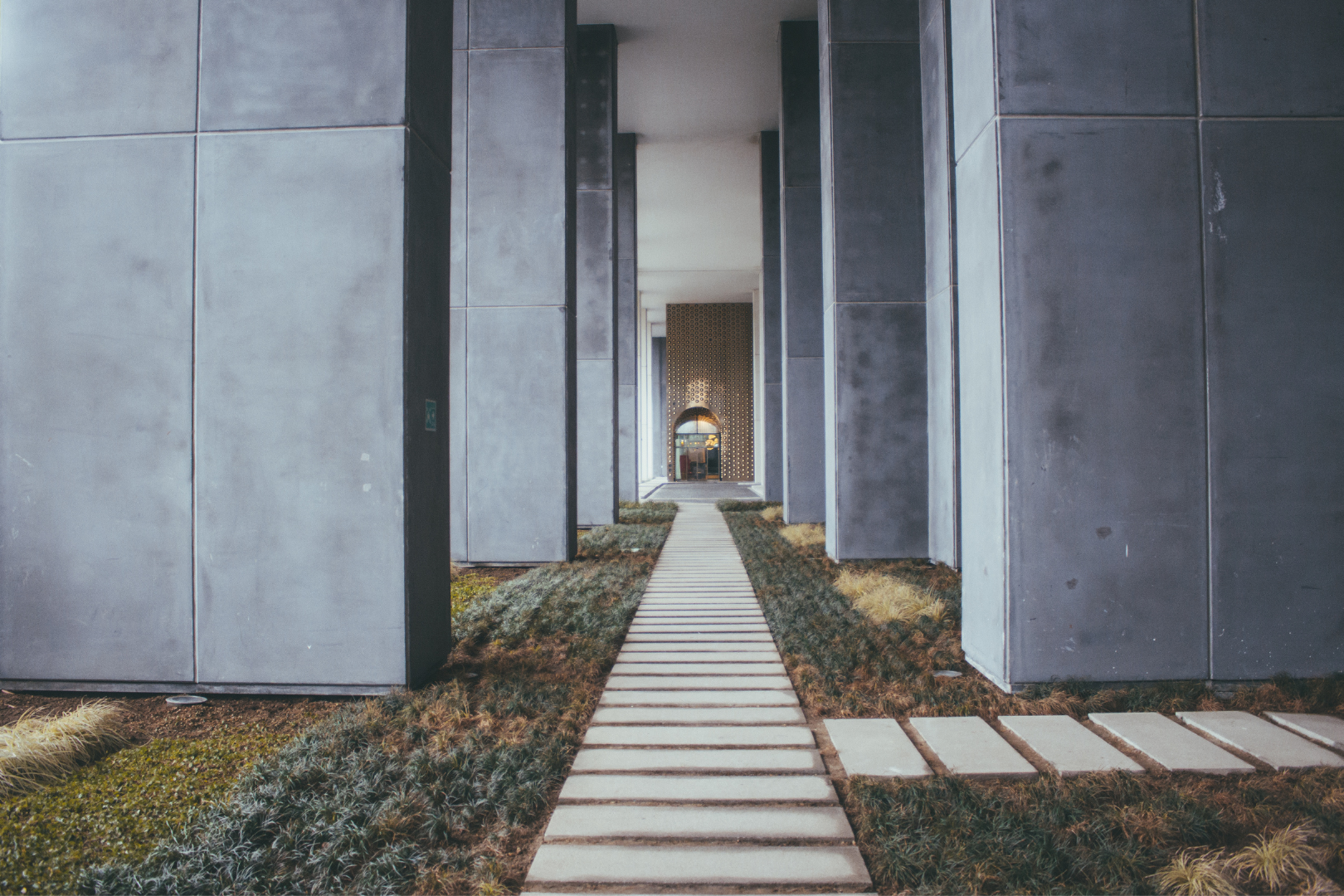 Concrete sidewalk under construction, with wooden forms and stakes.