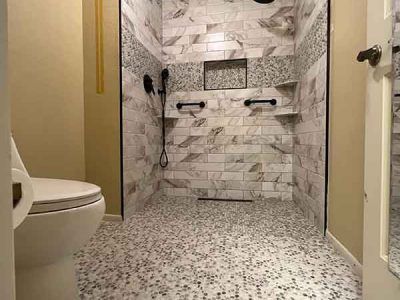 A bathroom with a walk in shower and a toilet.