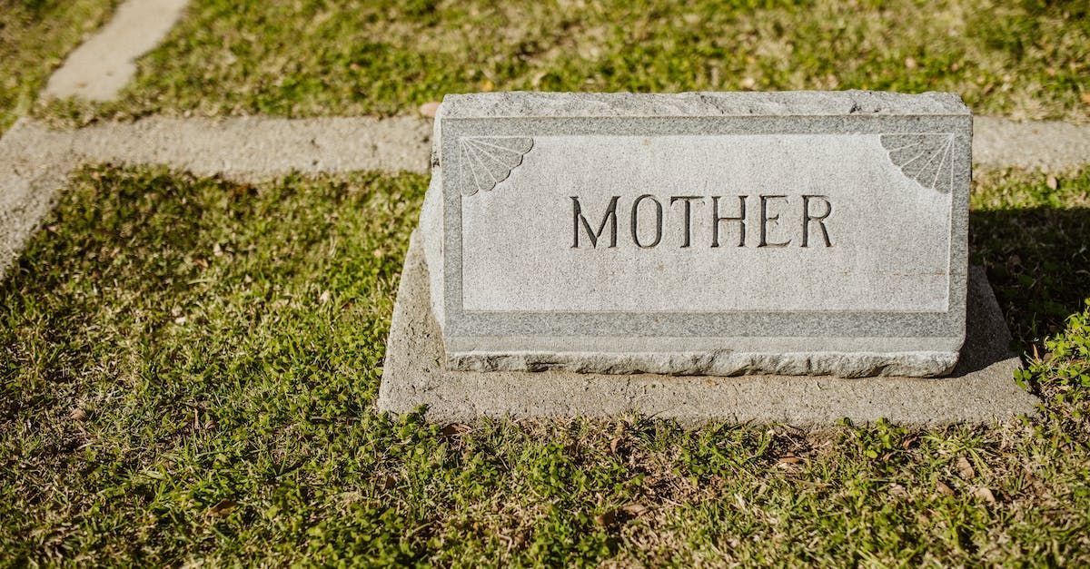 Gravestone marked “MOTHER” on a grassy lawn.