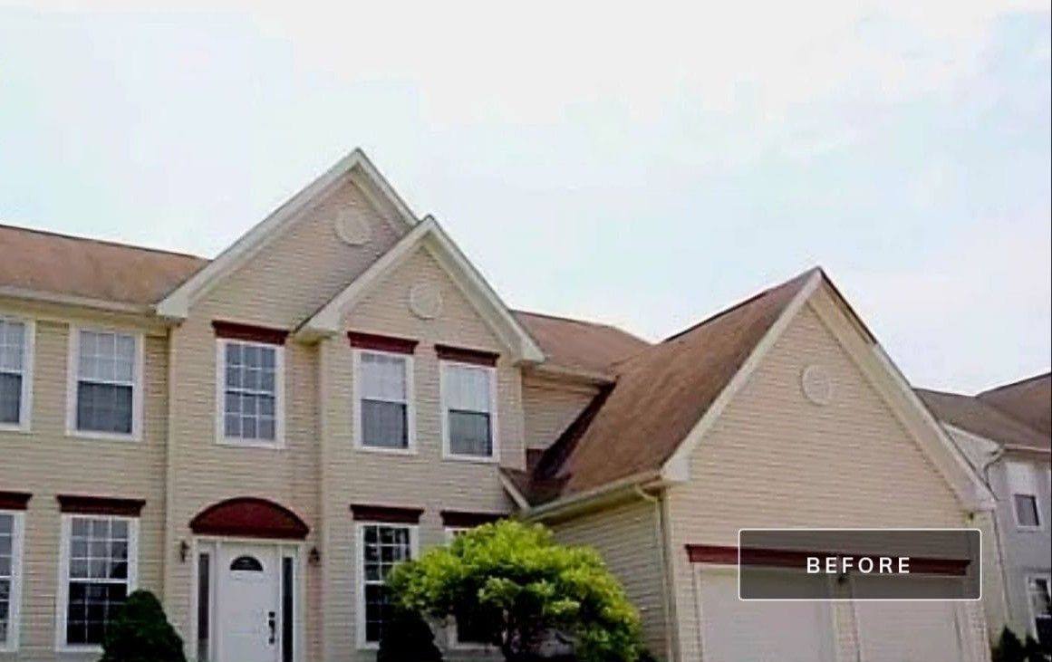 A large house with a brown roof and a white door.