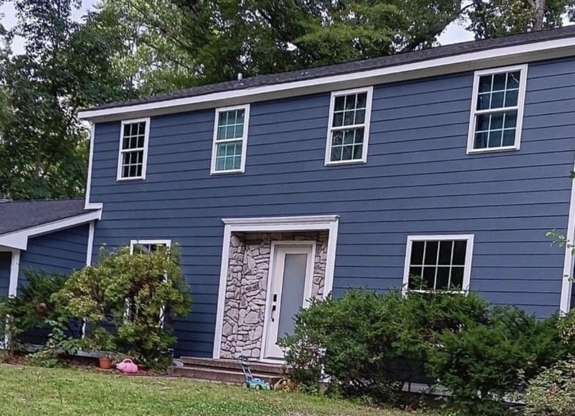 A house with two garage doors and a gray roof