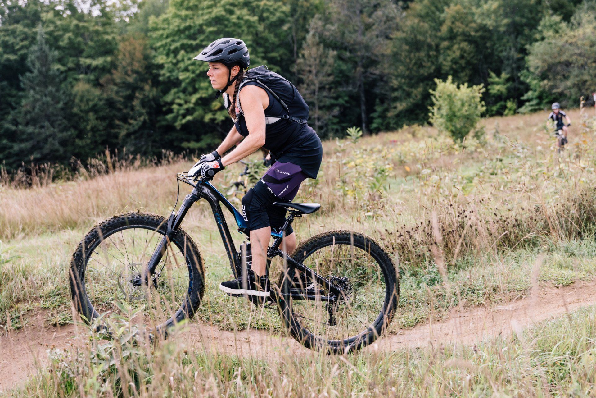 A woman rides one of the Kingdom Trails  at The Wildflower in East Burke during a Ladies All Ride Mountain Bike Clinic  