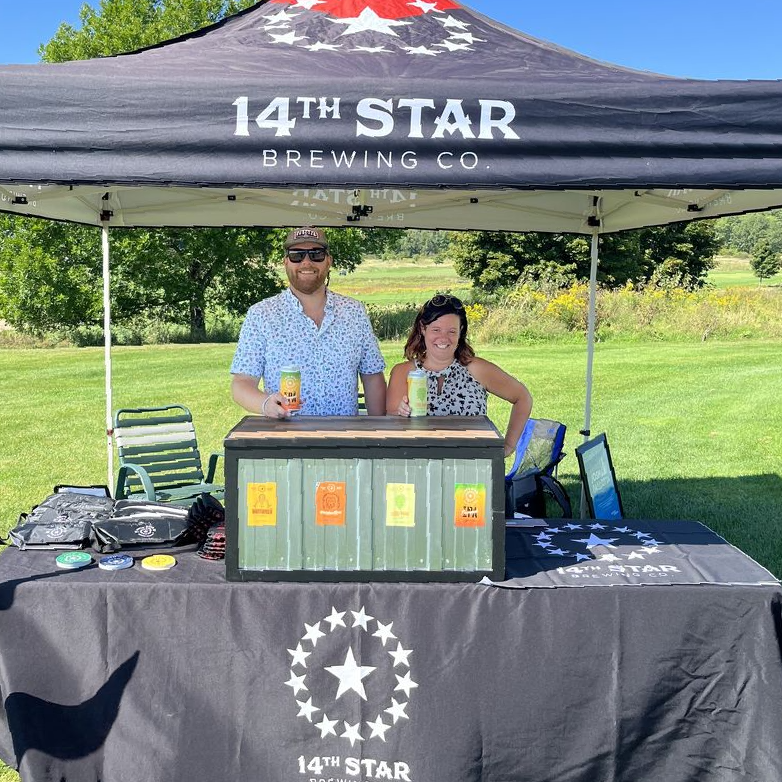 14th Star Brewing Company set up under an event tent in a field, serving delicious beers