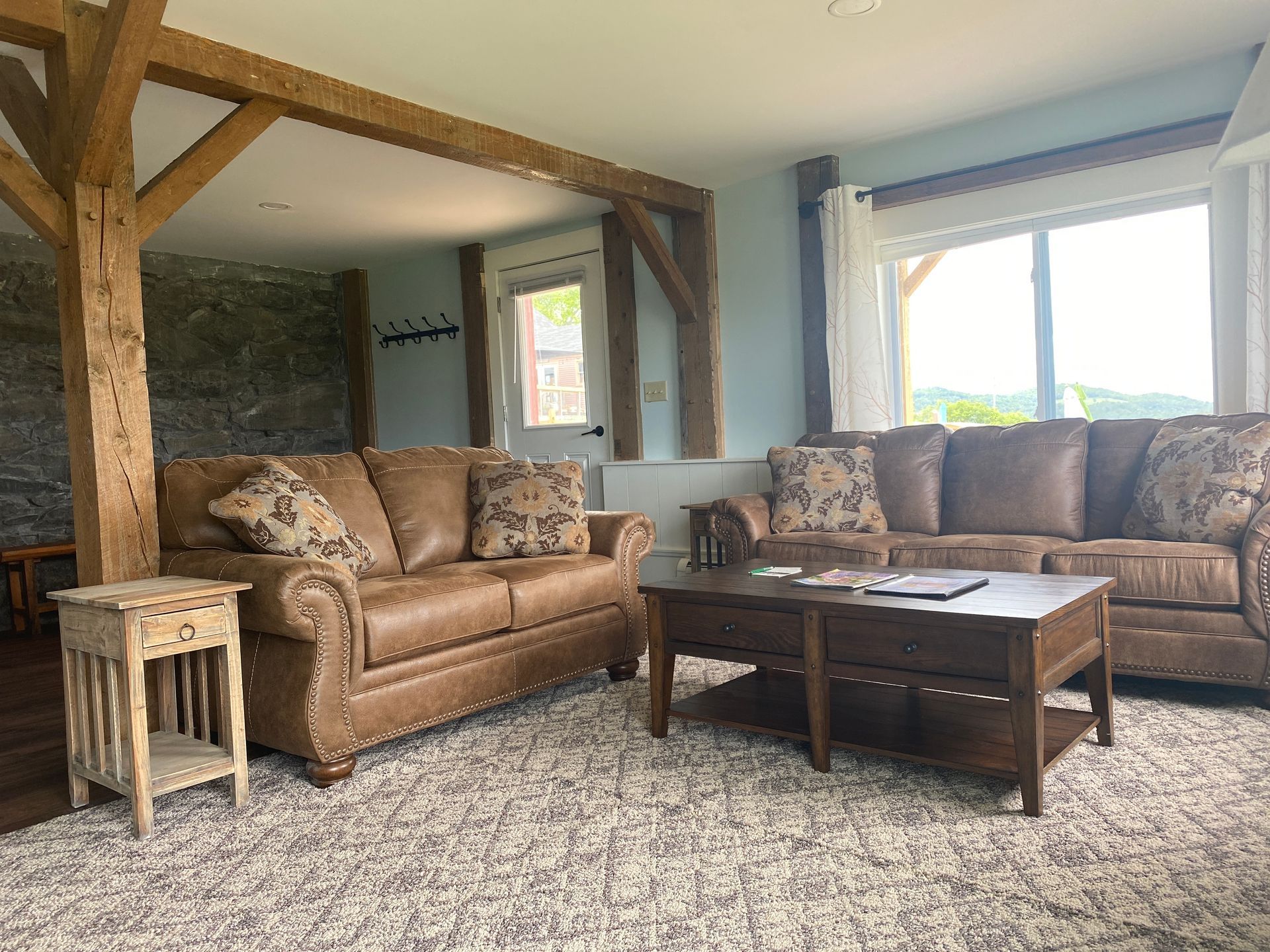 The Bemis Suite at the wildflower offers a full-sized living room with two couches and a coffee table