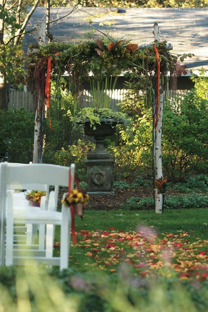 Wedding Arch and Aisle Covered With Fall Leaves