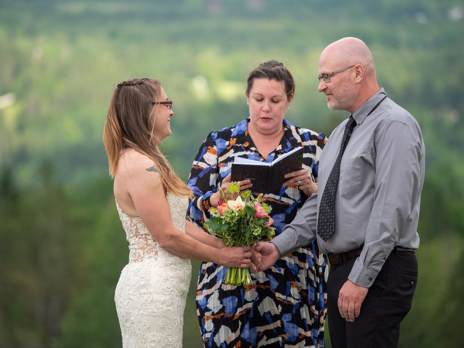 A bride and groom during their elopement ceremony on The Wildflower property in East Burke, Vermont
