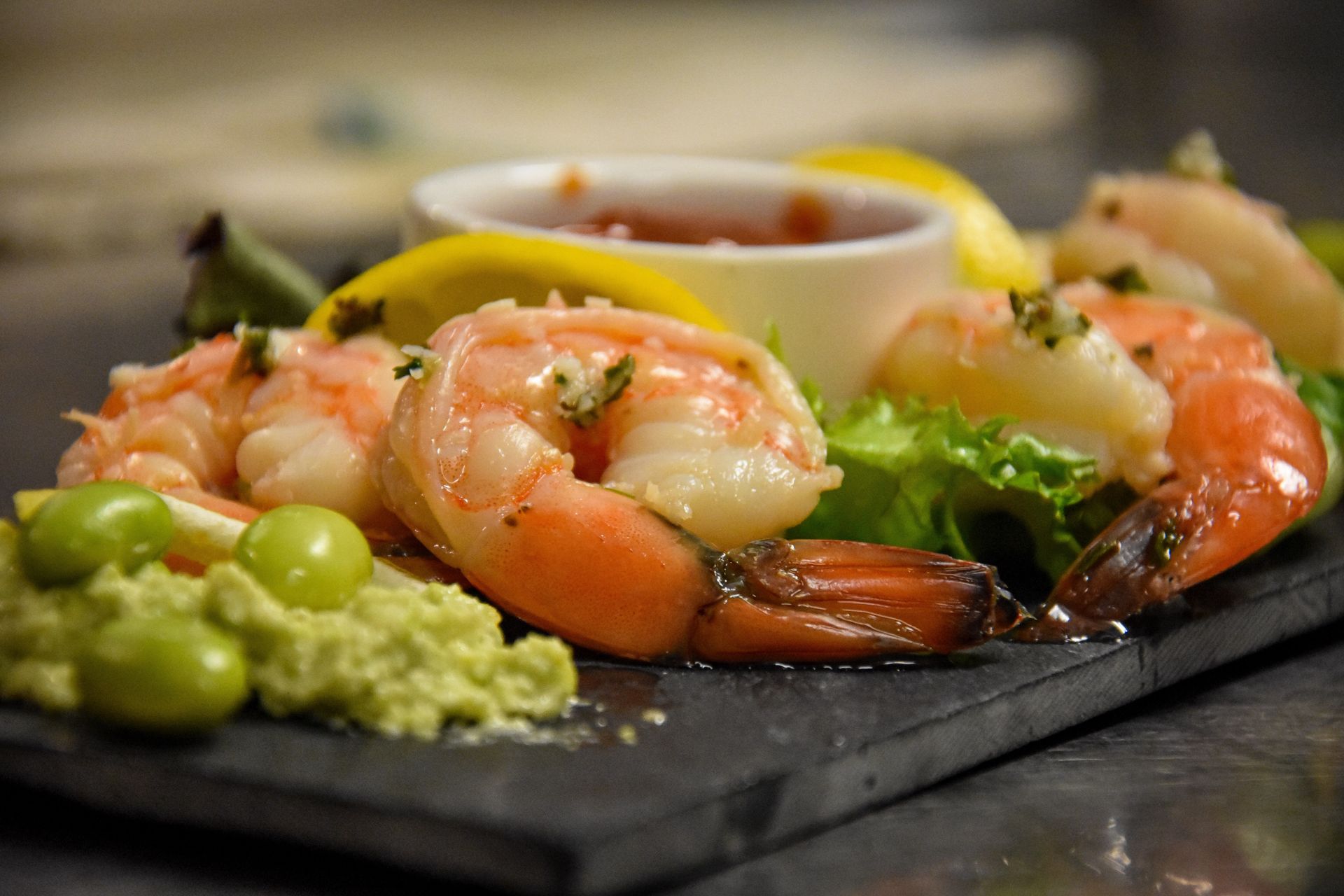 Closeup of shrimp, lemon, and lima bean meal.