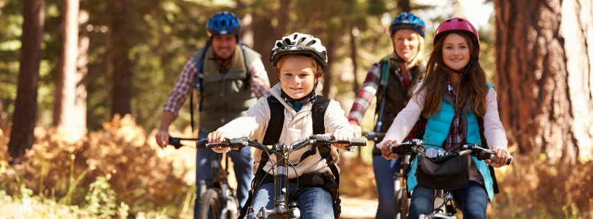 A family goes for a bike ride on the mountain biking trails surrounding The Wildflower in East Burke, Vermont