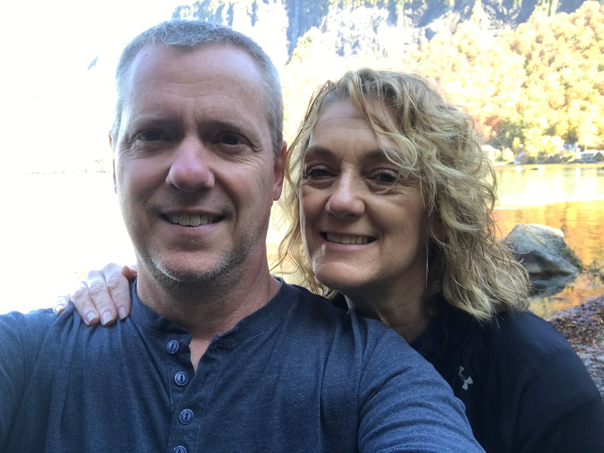 A selfie shot of two people with Mount Pisgah in the background.