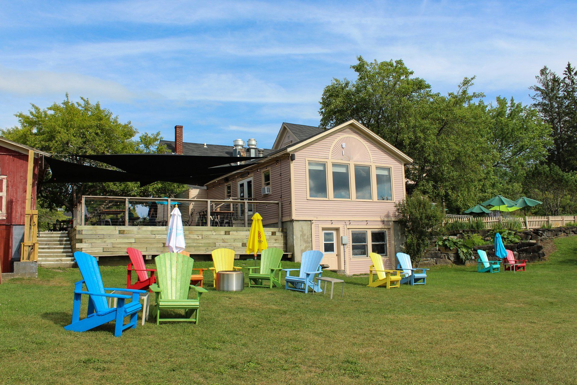 The go-to lounging area in East Burke at The Wildflower with rainbow Adirondacks and stunning sunsets