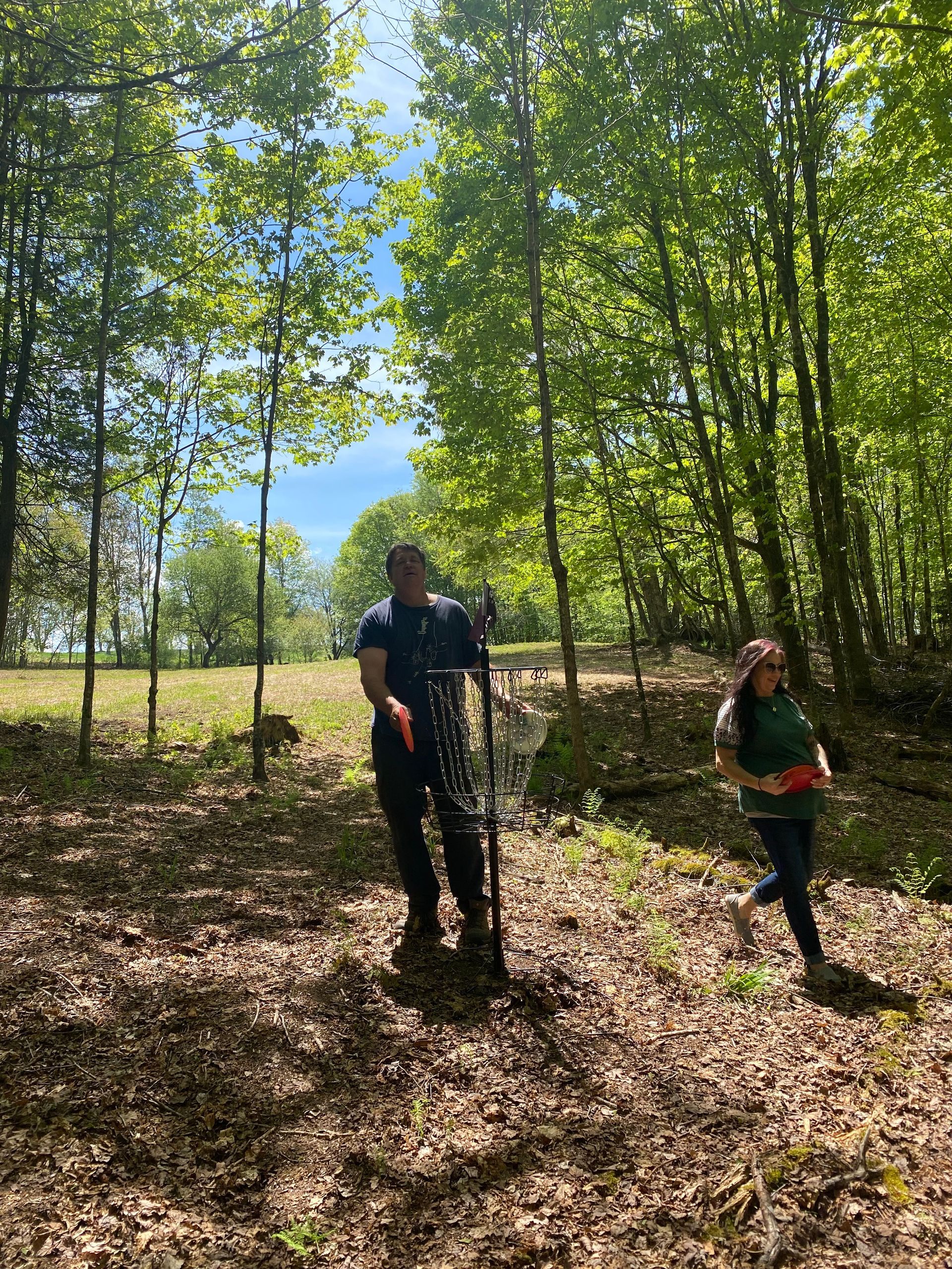 A man and a woman are playing disc golf at the Wildflower Inn in Vermont