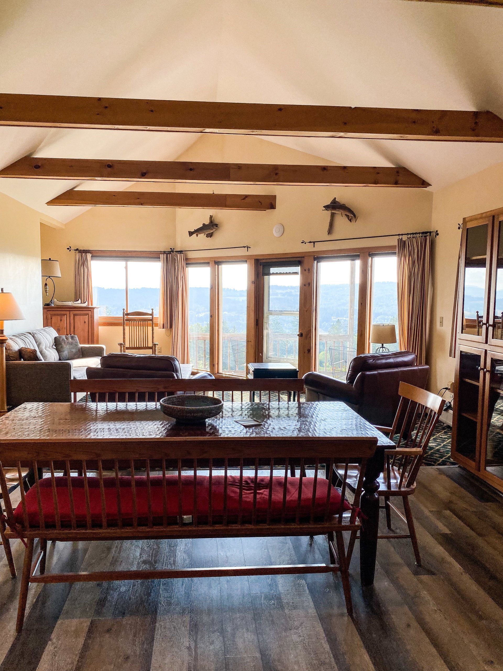 A living room with a table and chairs and a bench