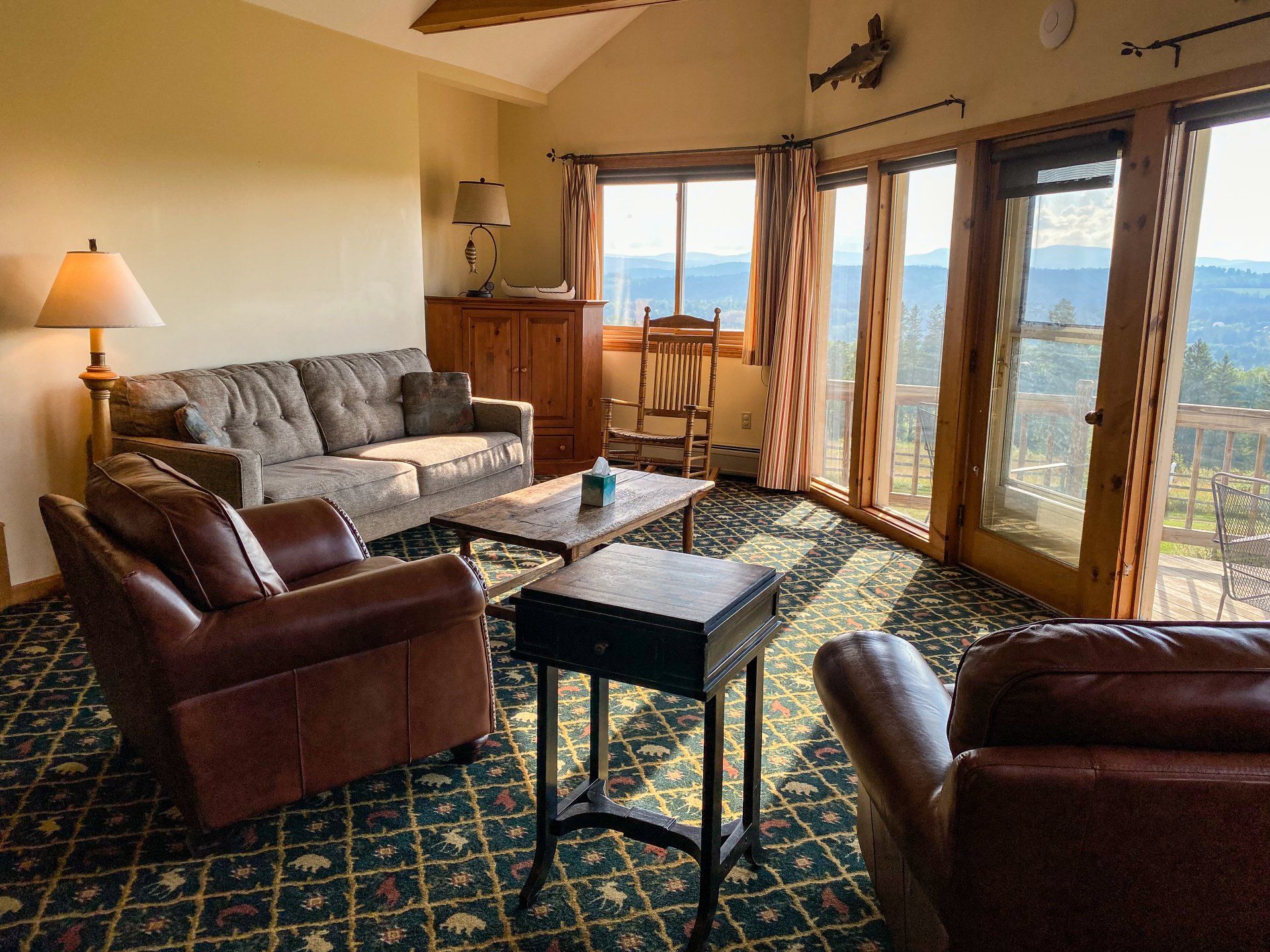 A living room with a couch , chairs , and a table.