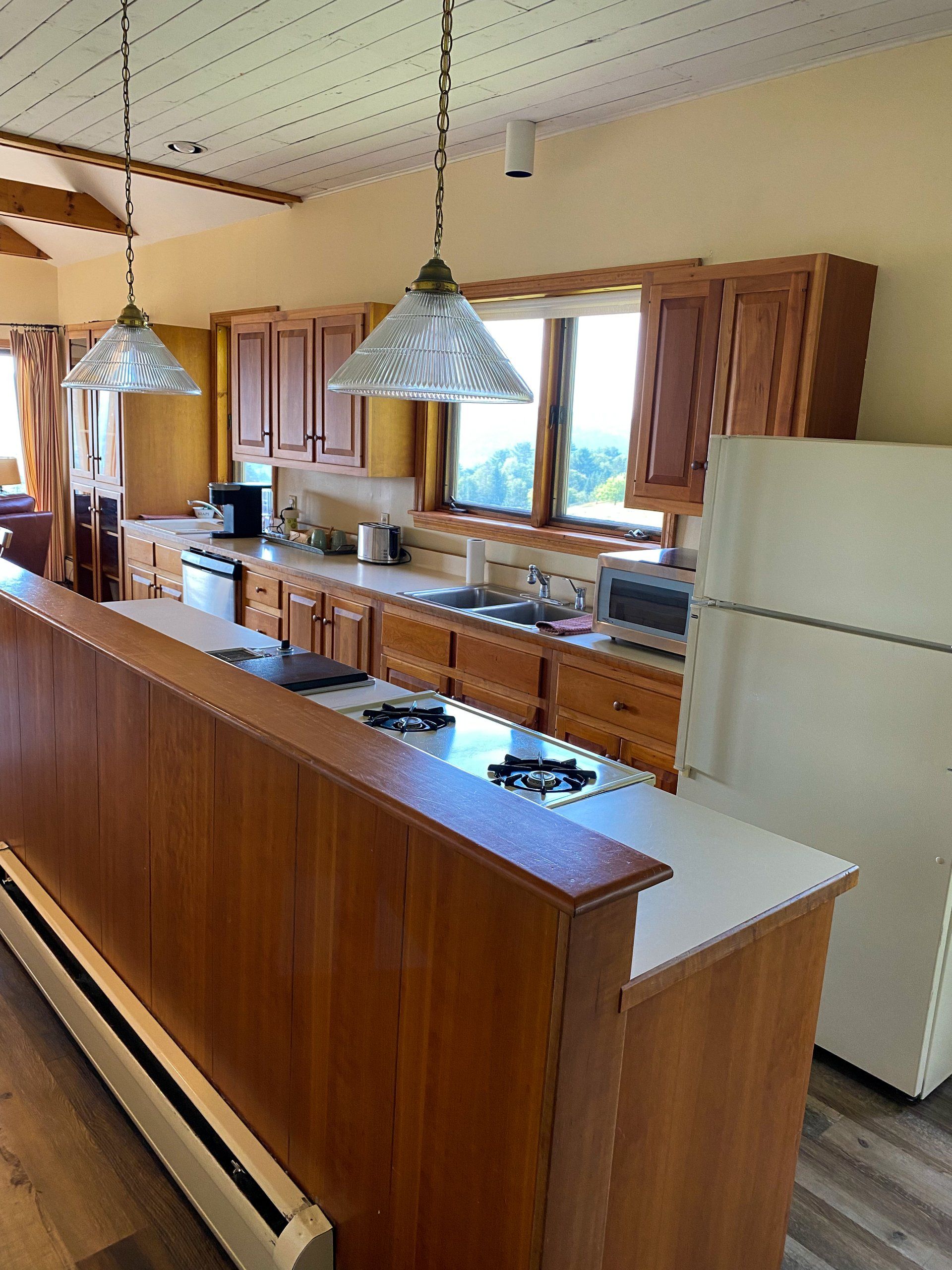 A kitchen with wooden cabinets and a white refrigerator