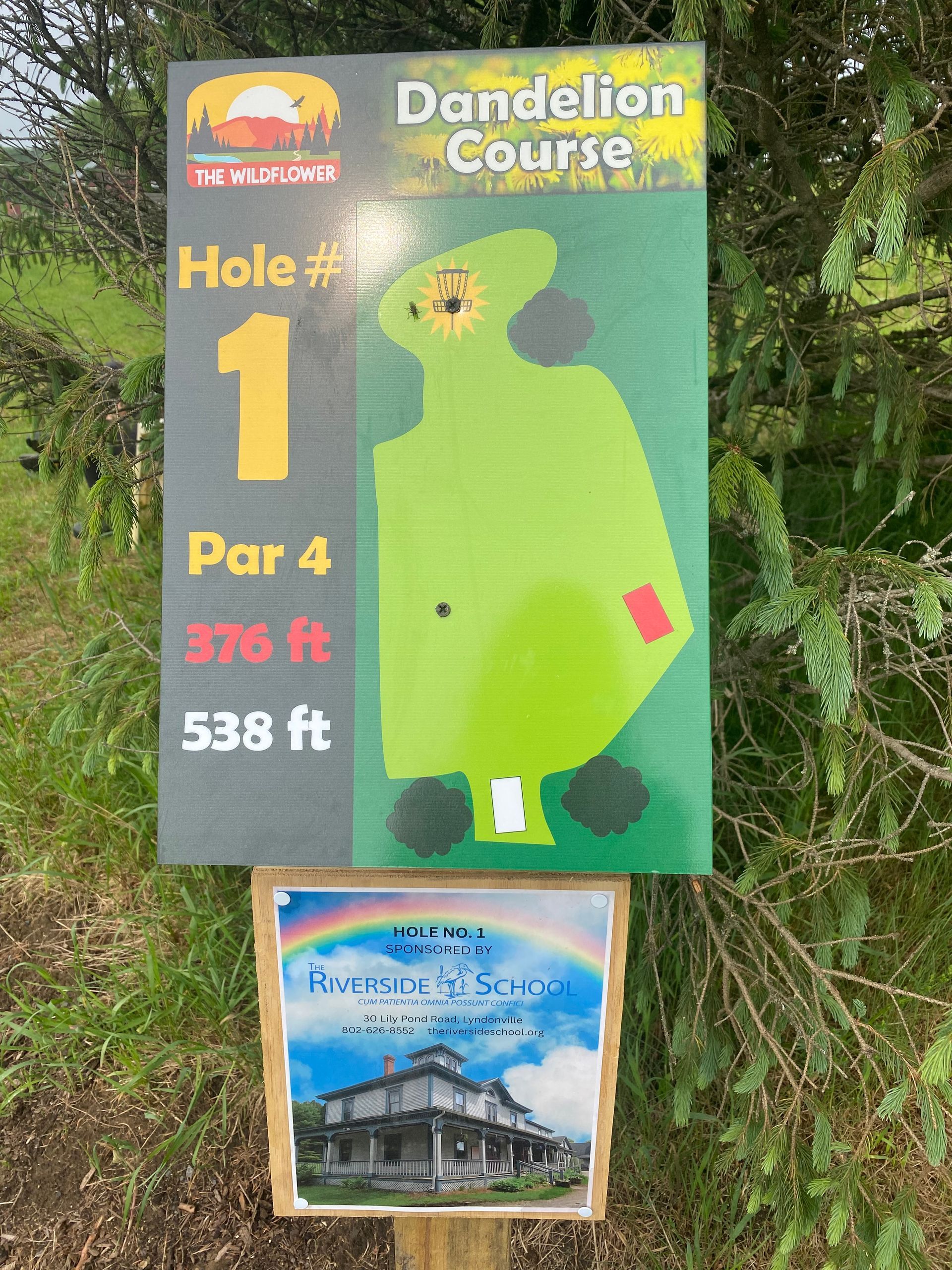 A sign for hole 1 of the disc golf course at the Wildflower Inn.