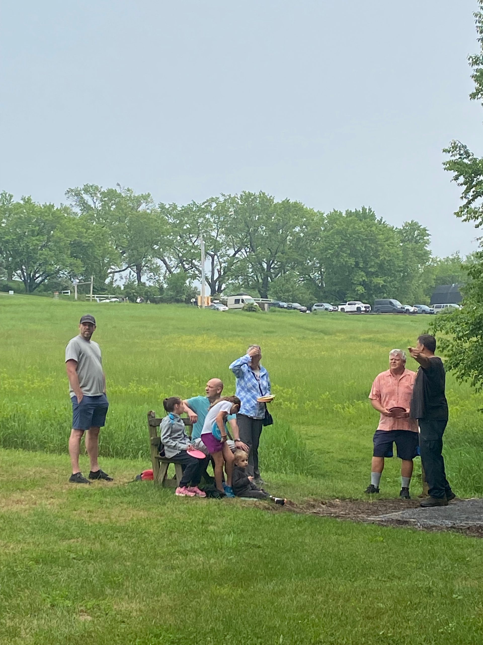A group of people are standing in a grassy field at the Wildflower Inn on Darling Hill in Vermont.