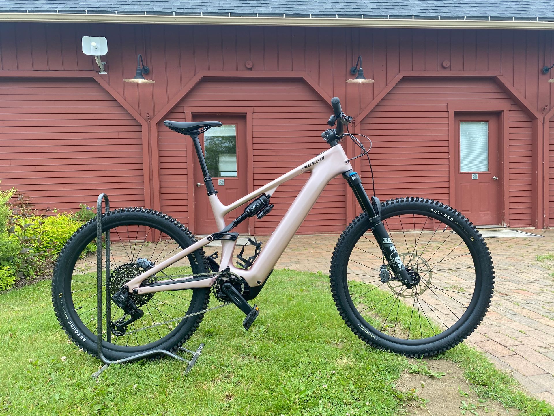 A bicycle is parked in front of a red building.