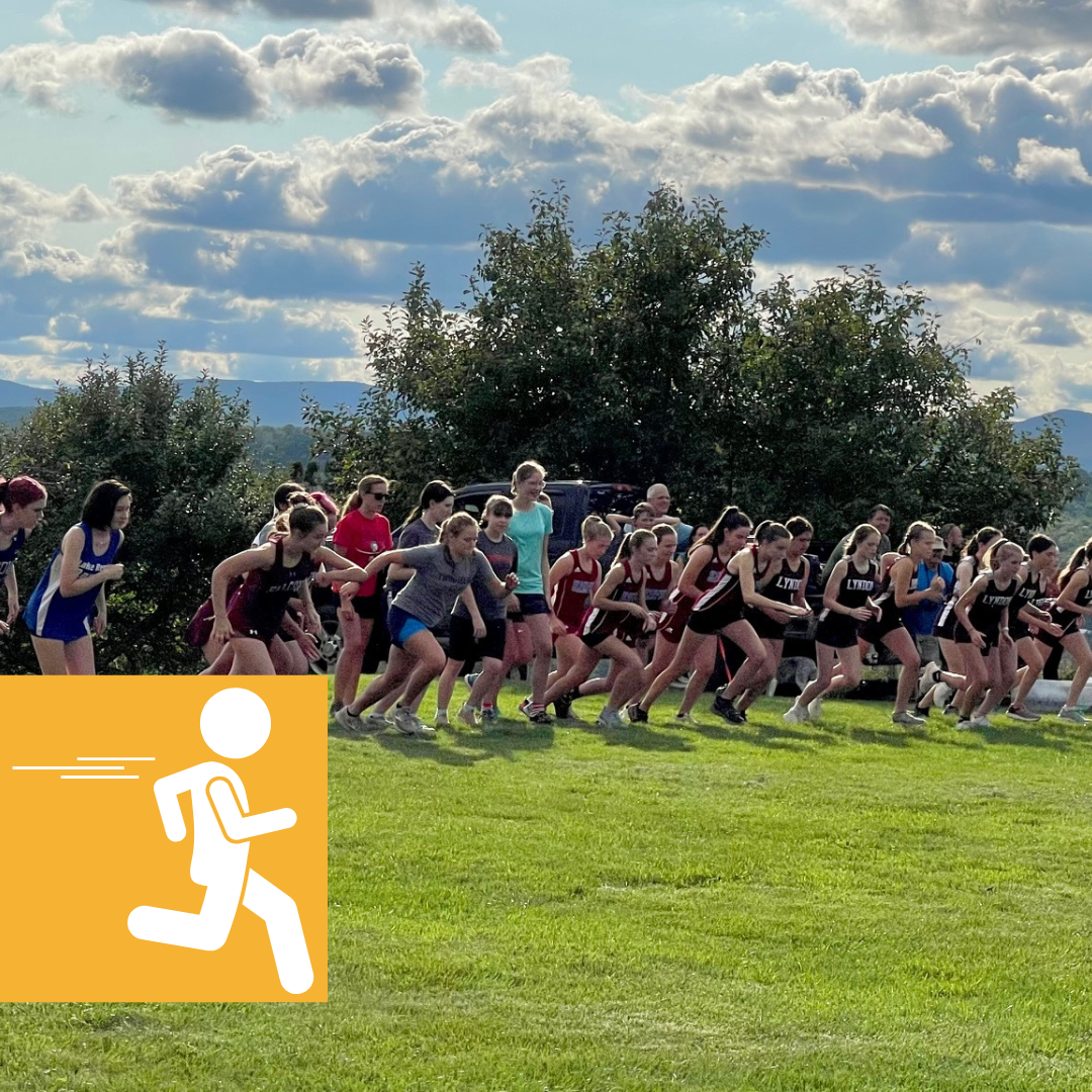 A group of people are running on a grassy field.