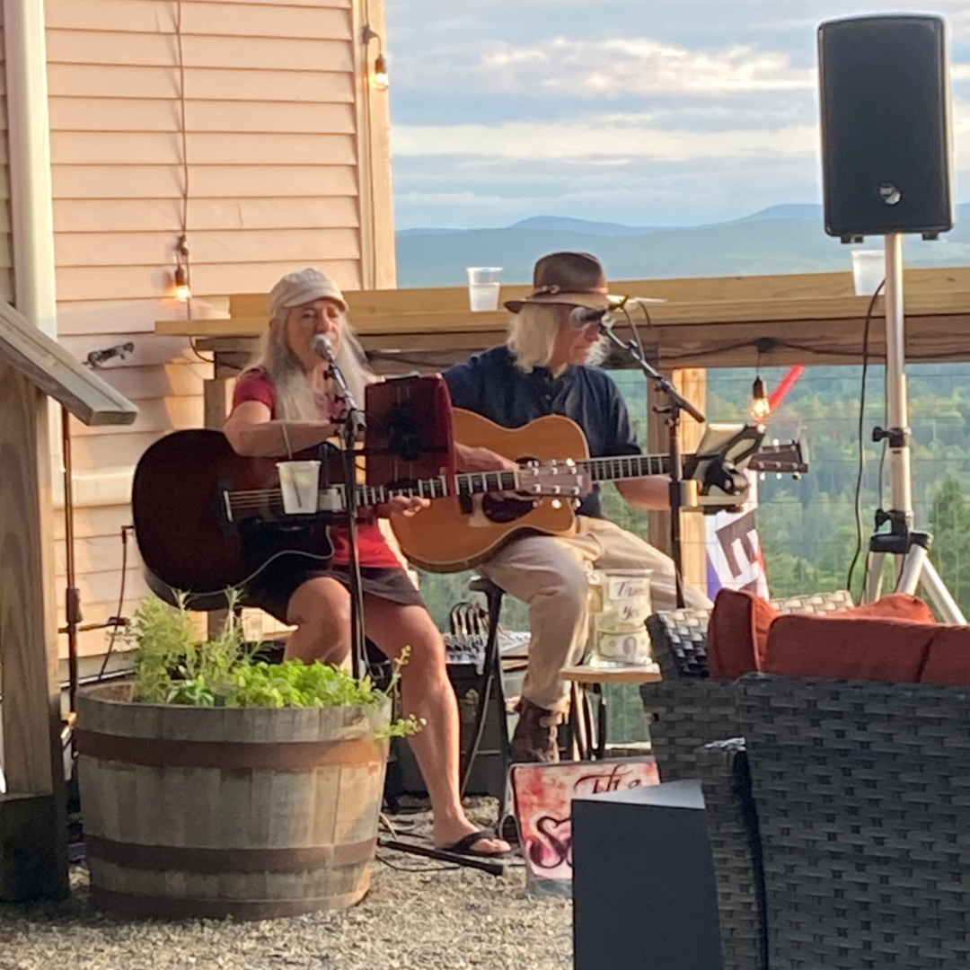 Two musicians performing a live concert in Vermont.