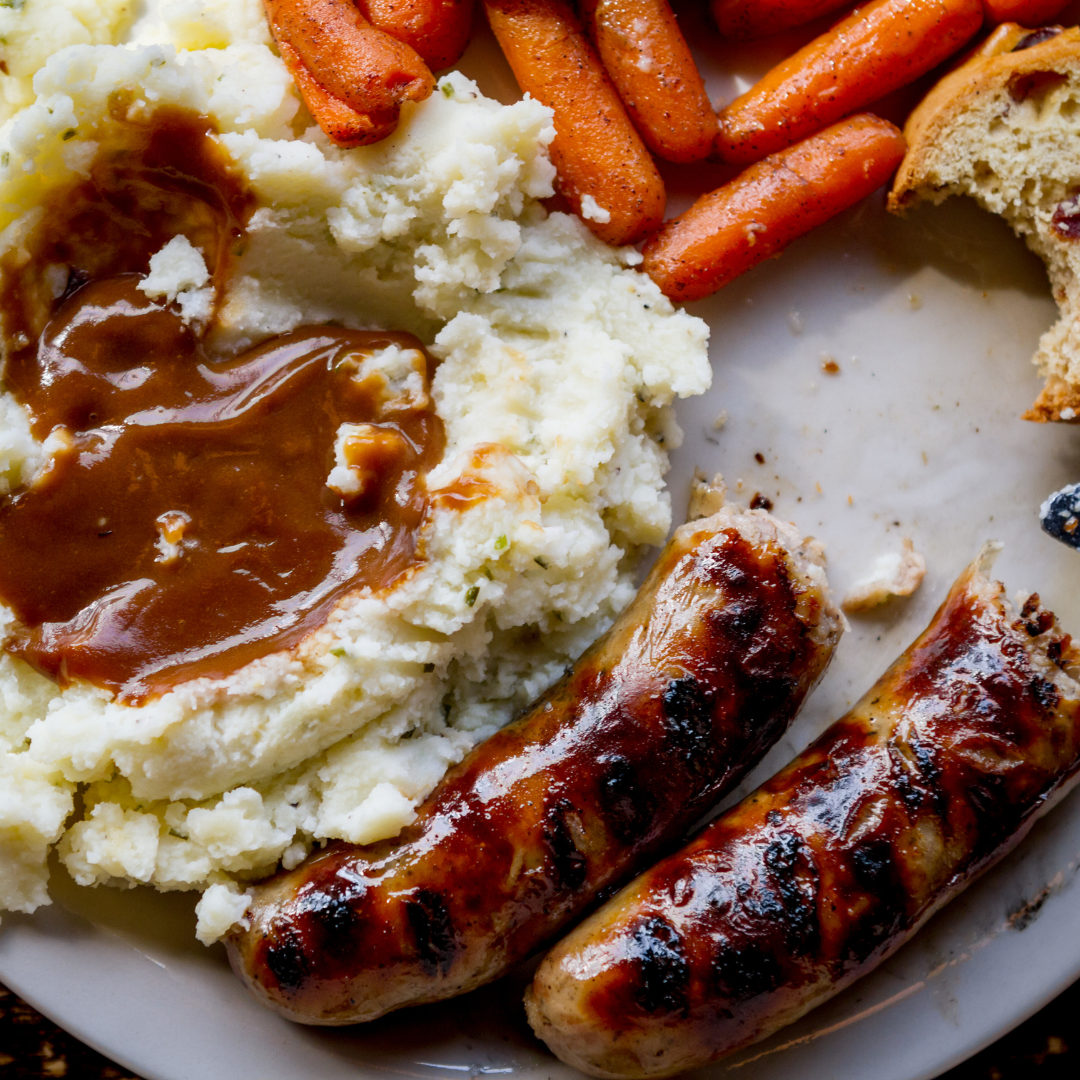 Bangers and mash with carrots and onion gravy