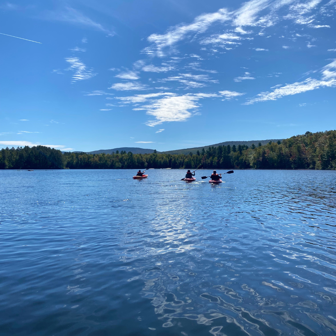 Three kayakers on Spectacle Pond
