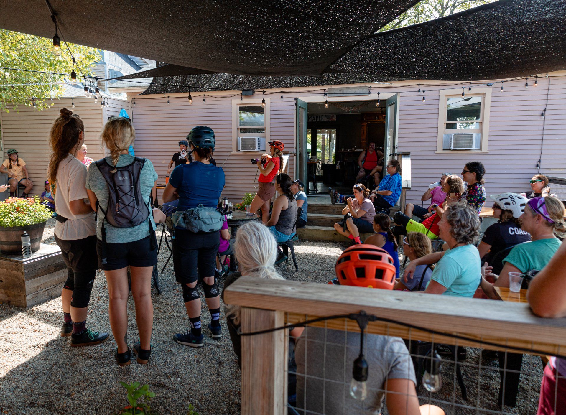 A group of event attendees enjoy The Wildflower Restaurant's Beer Garden following a mountain biking event 