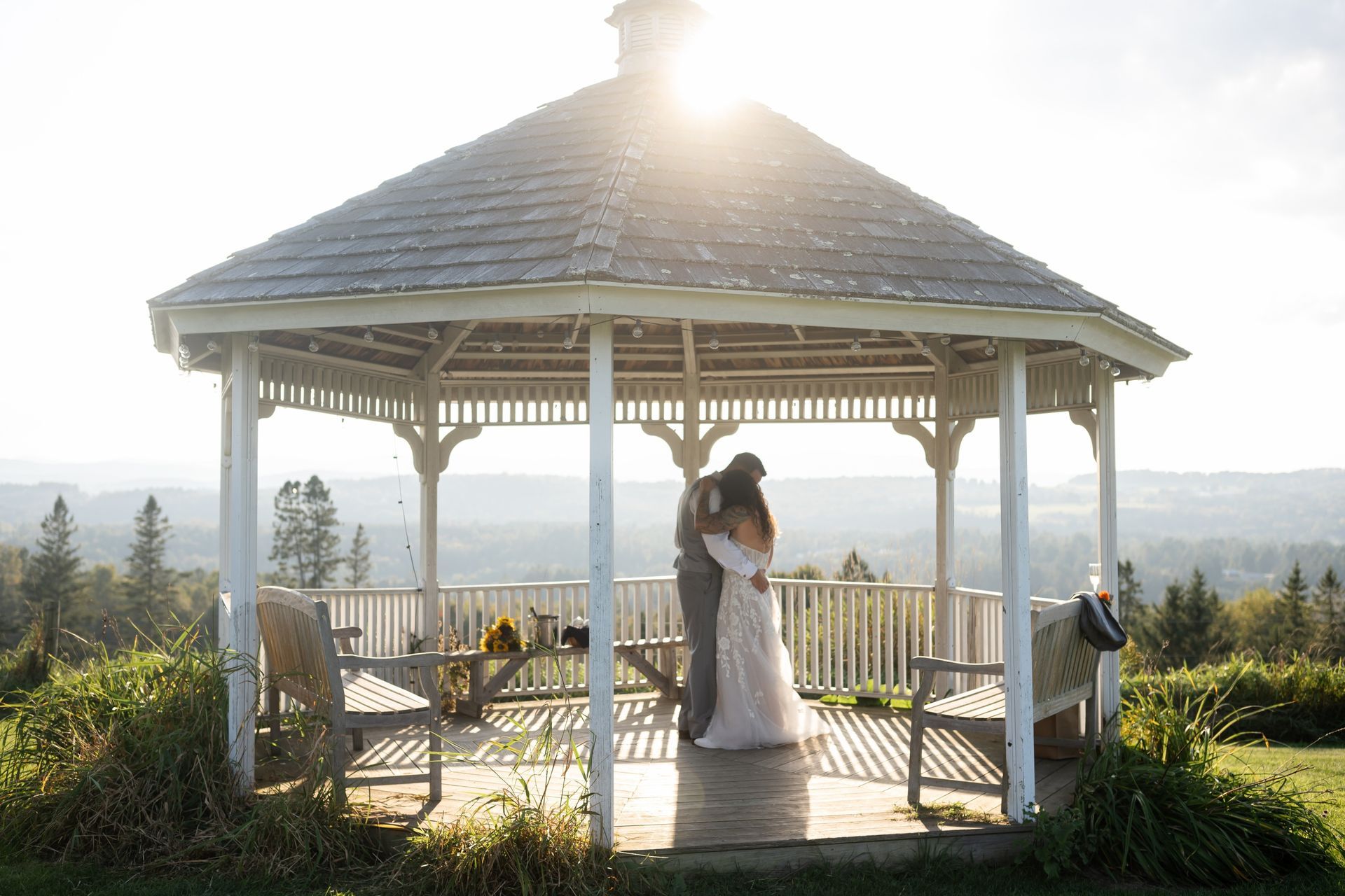 A bride and groom sit atop their motorcycle after their Vermont elopement at The Wildflower
