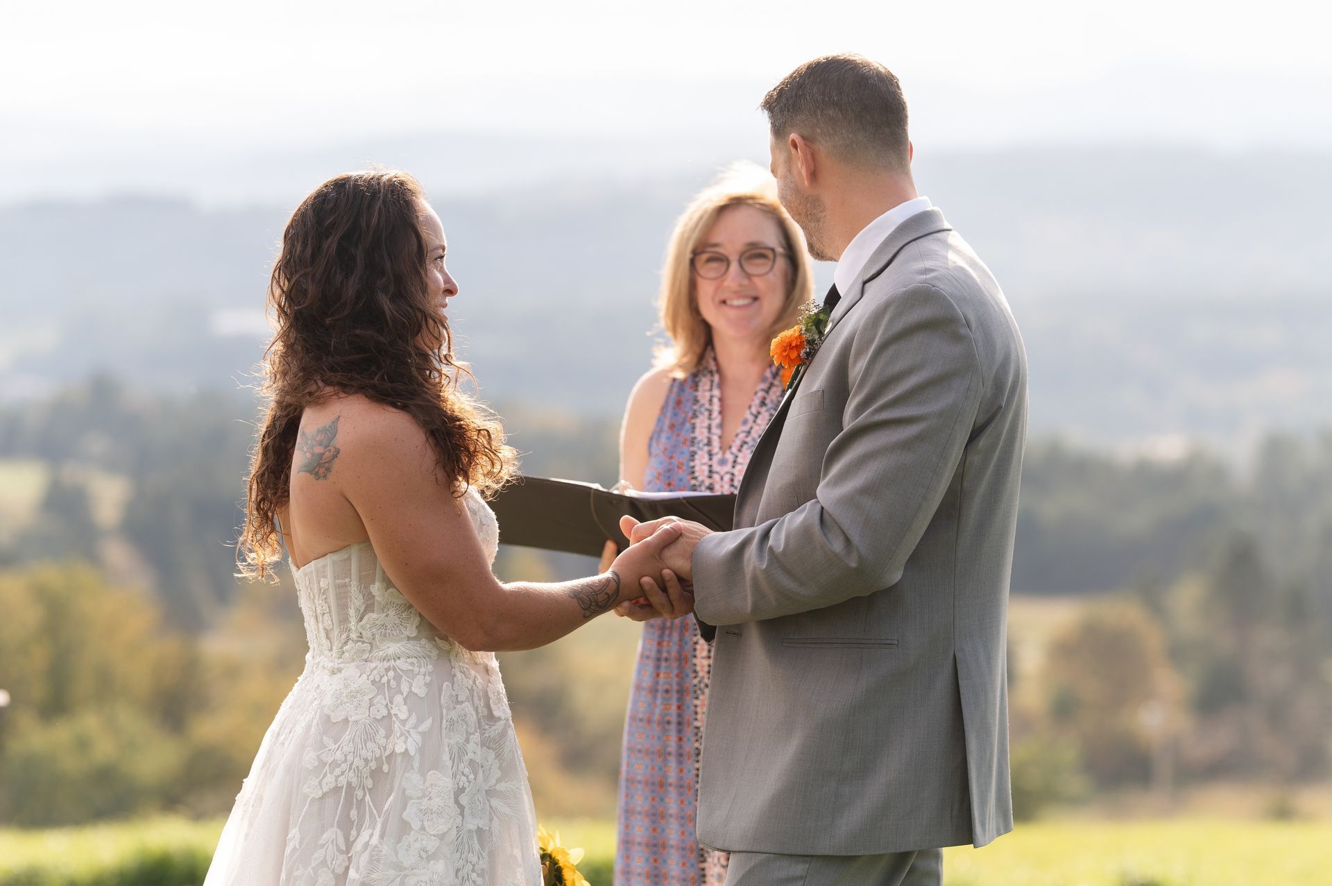 A bride and groom say their vows in front of the beautiful mountains at The Wildflower