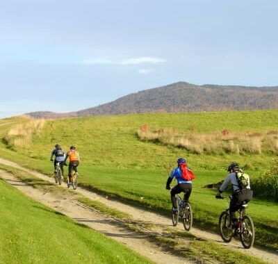 A group of mountain bikers heading up the hill on the Kingdom Trails network