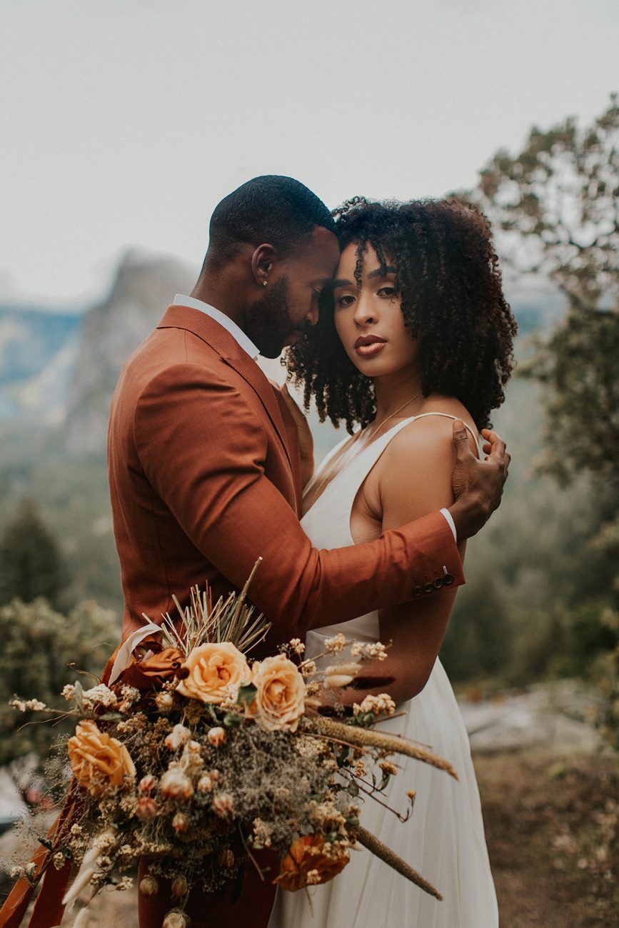 Fall wedding in Yosemite man wearing rust orange tux
