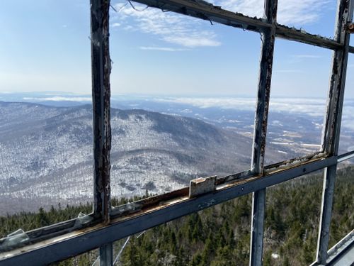 A view of a mountain range through a window.