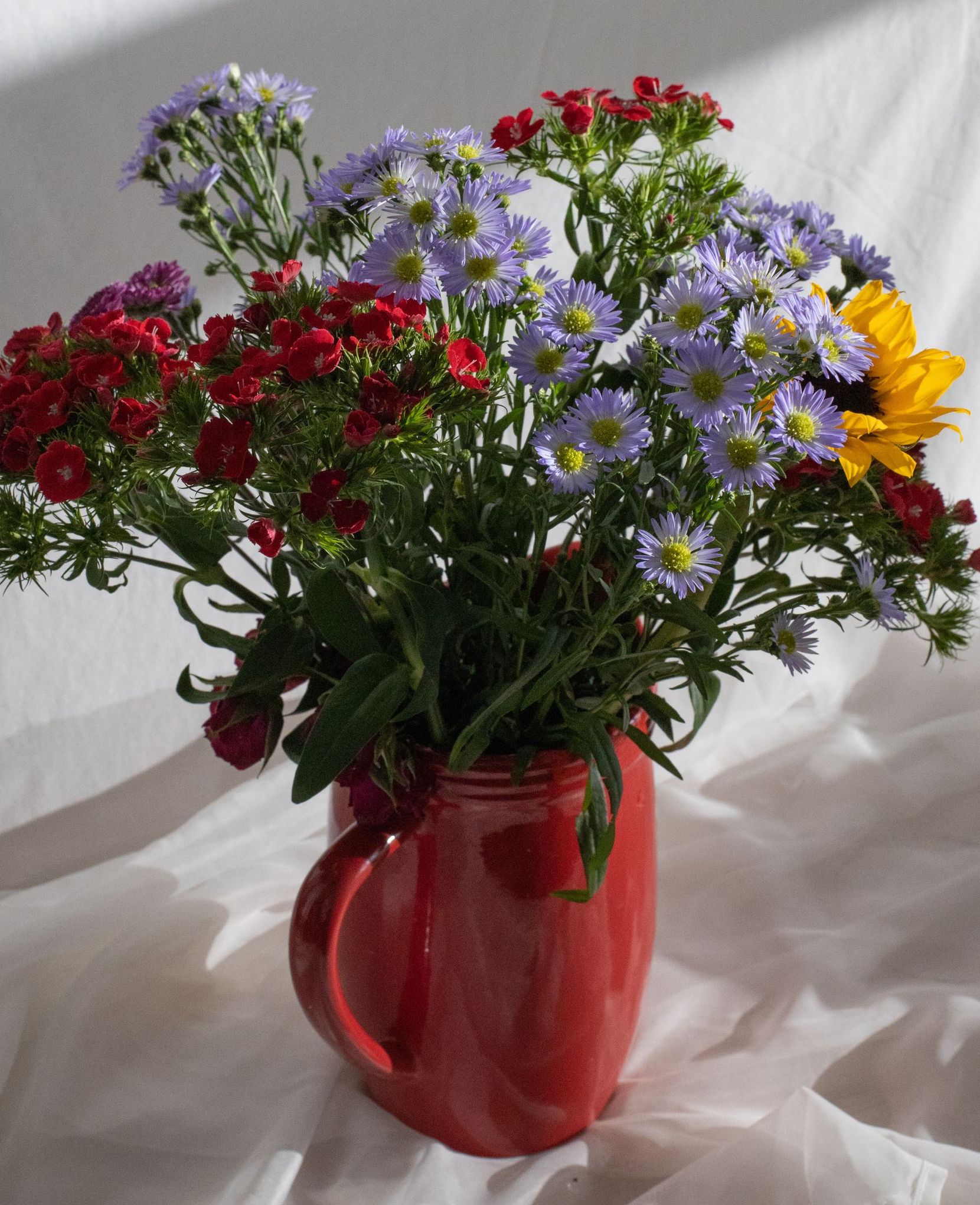 Bouquet of wildflowers in red vase