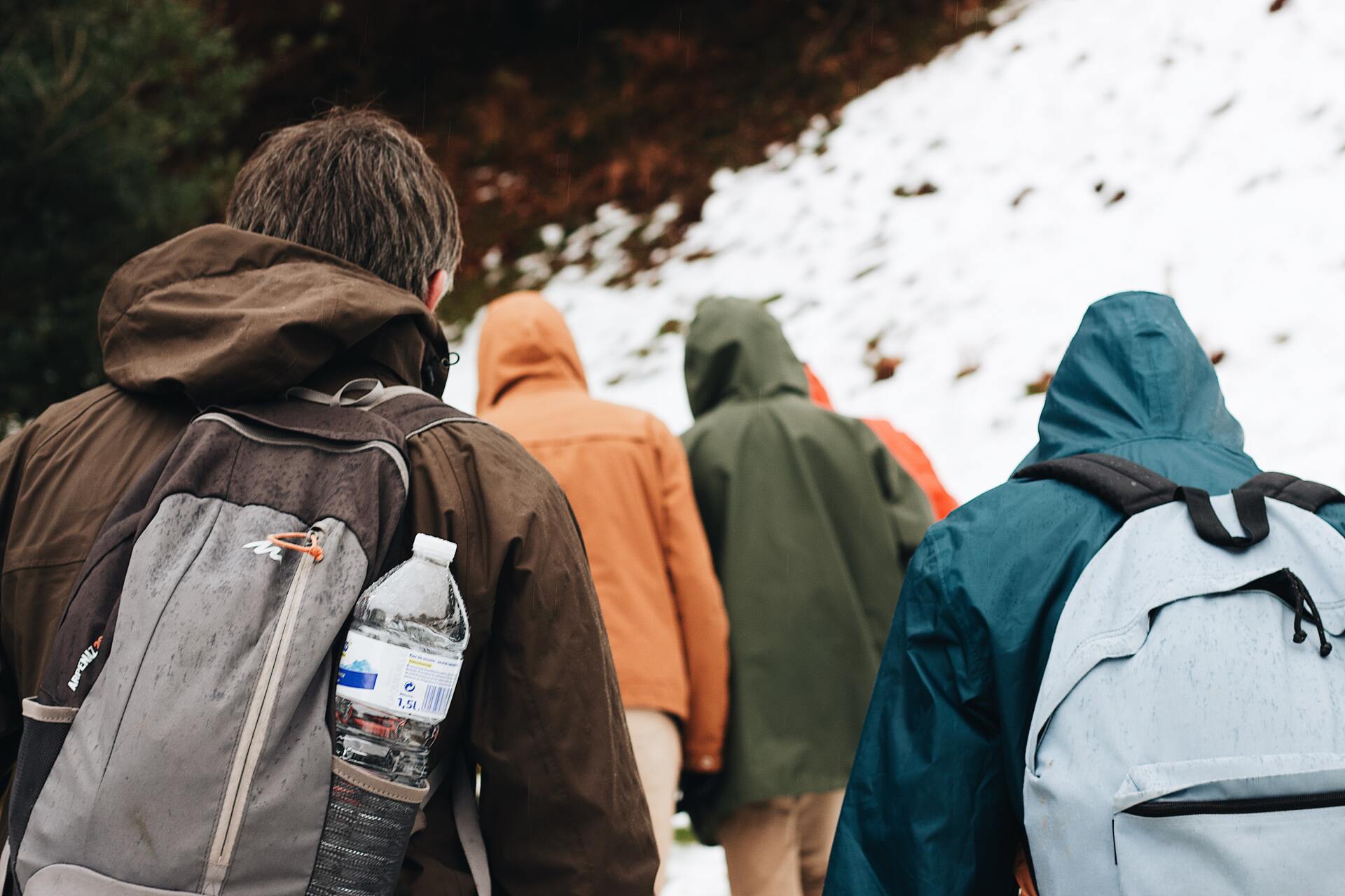 Group of hikers with water bottles in their packs
