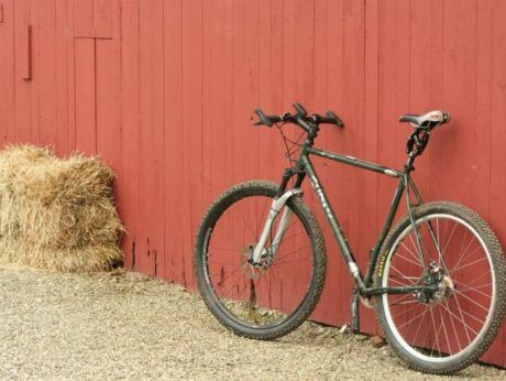 A mountain bike leans against The Wildflower barn