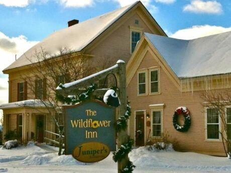 A house with a sign that says the wildflower inn