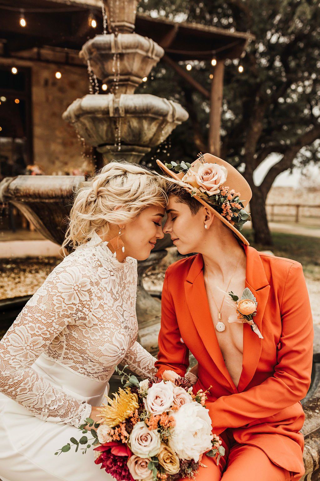 LGBTQ Couple at their wedding, in front of a fountain