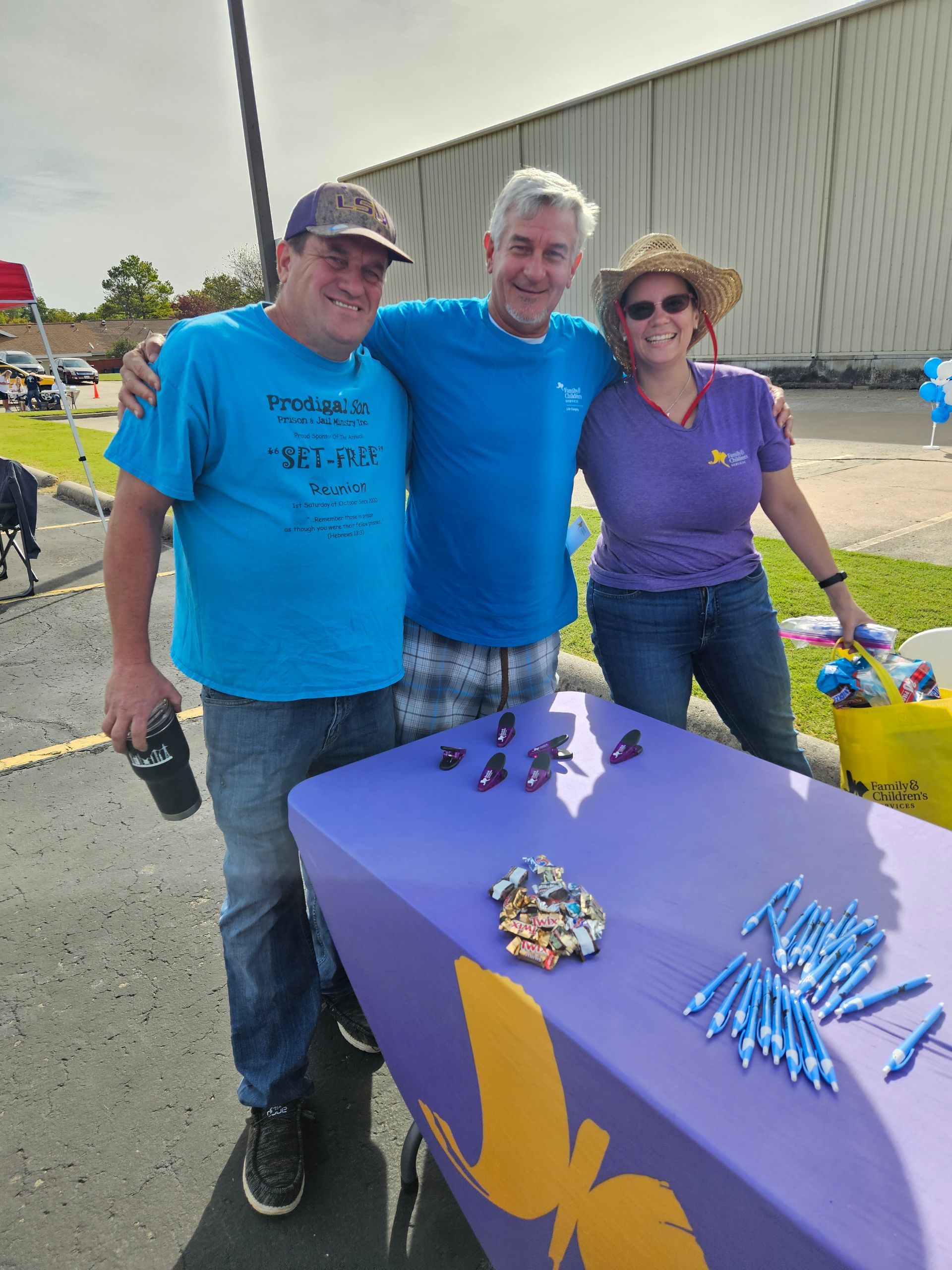 A group of people standing around a table with a butterfly on it