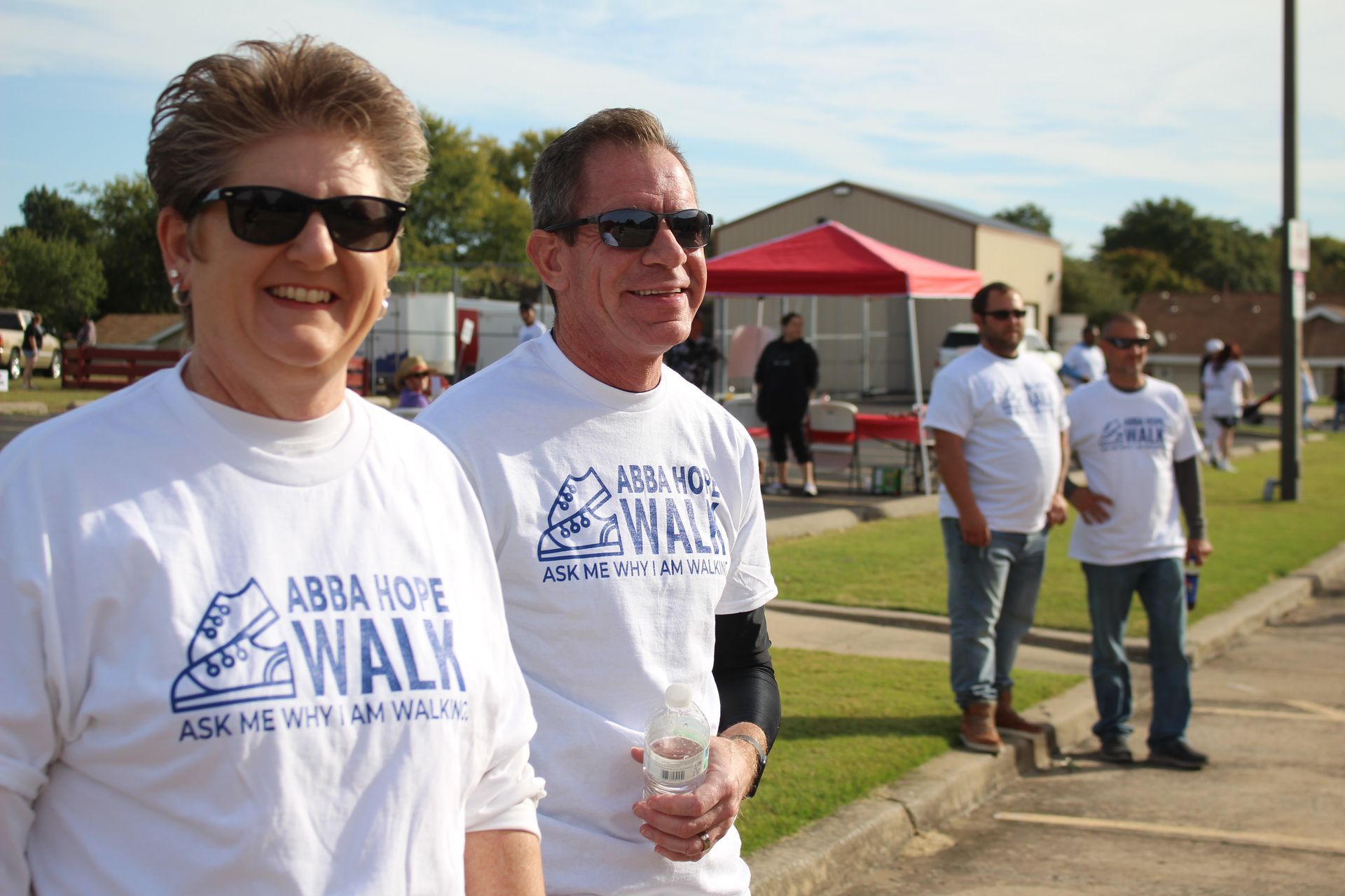 A group of people wearing abba hope walk shirts