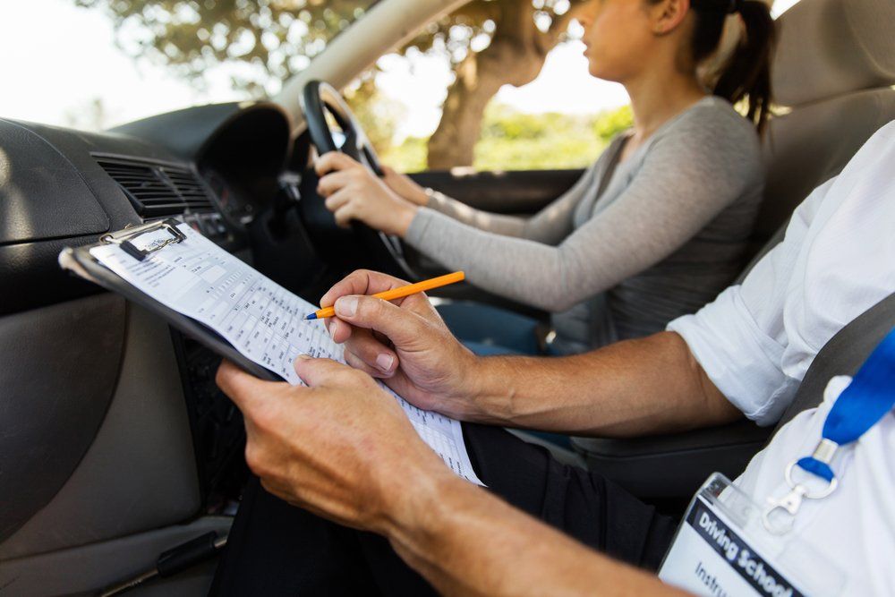 man checking student driving checklist