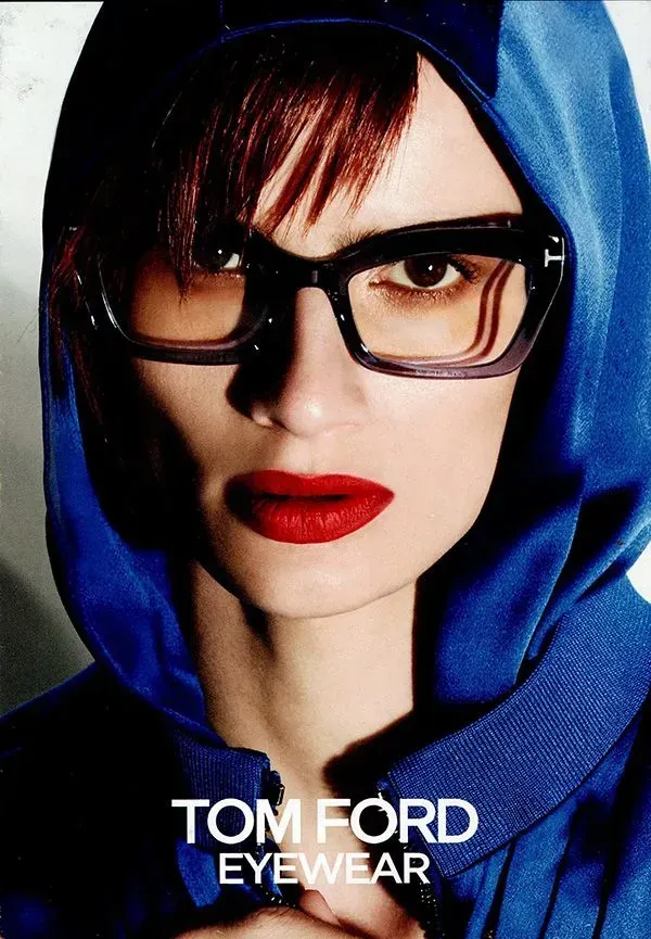A woman wearing glasses and a blue hoodie for tom ford eyewear