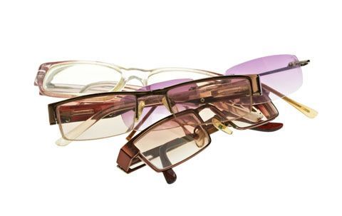 Three pairs of glasses are stacked on top of each other on a white background.