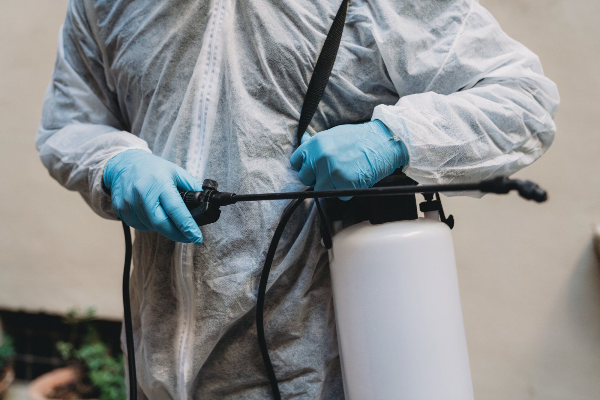 Protective Suit Holding Sprayer - Mansfield, OH - 360 Pest Solutions