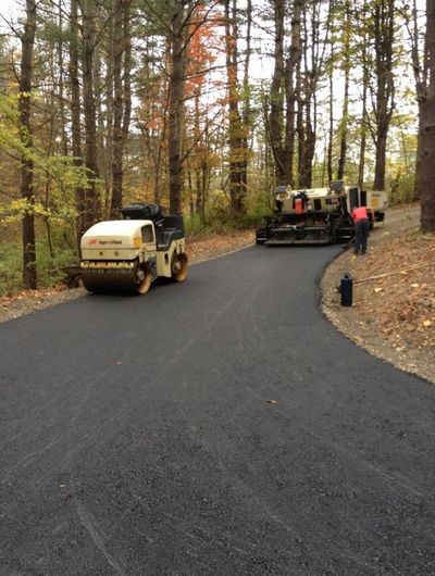 Gravel Driveways — Workers Repairing Asphalt Road in Ithaca, NY