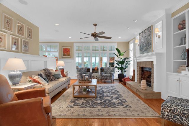 residential design for living room with custom wide fireplace against a floor to ceiling  display shelf