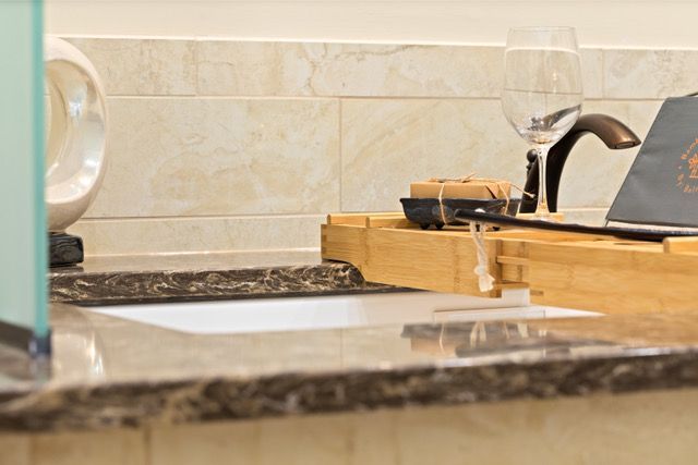 traditional bathroom and vanity with a pillar and stained glass window